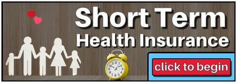 Wooden wall with a paper cutout of a family alongside a paper heart and a small clock. White letters spell out Short Term Health Insurance.